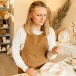 Pottery artisan working with clay, showcasing creativity in a well-lit workshop setting.